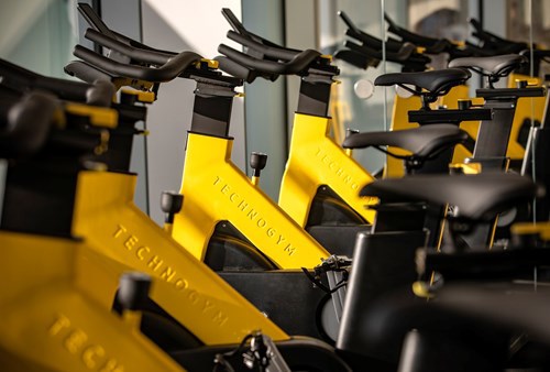 Technogym equipment is in the resident gym at Newfoundland including yellow spin bikes