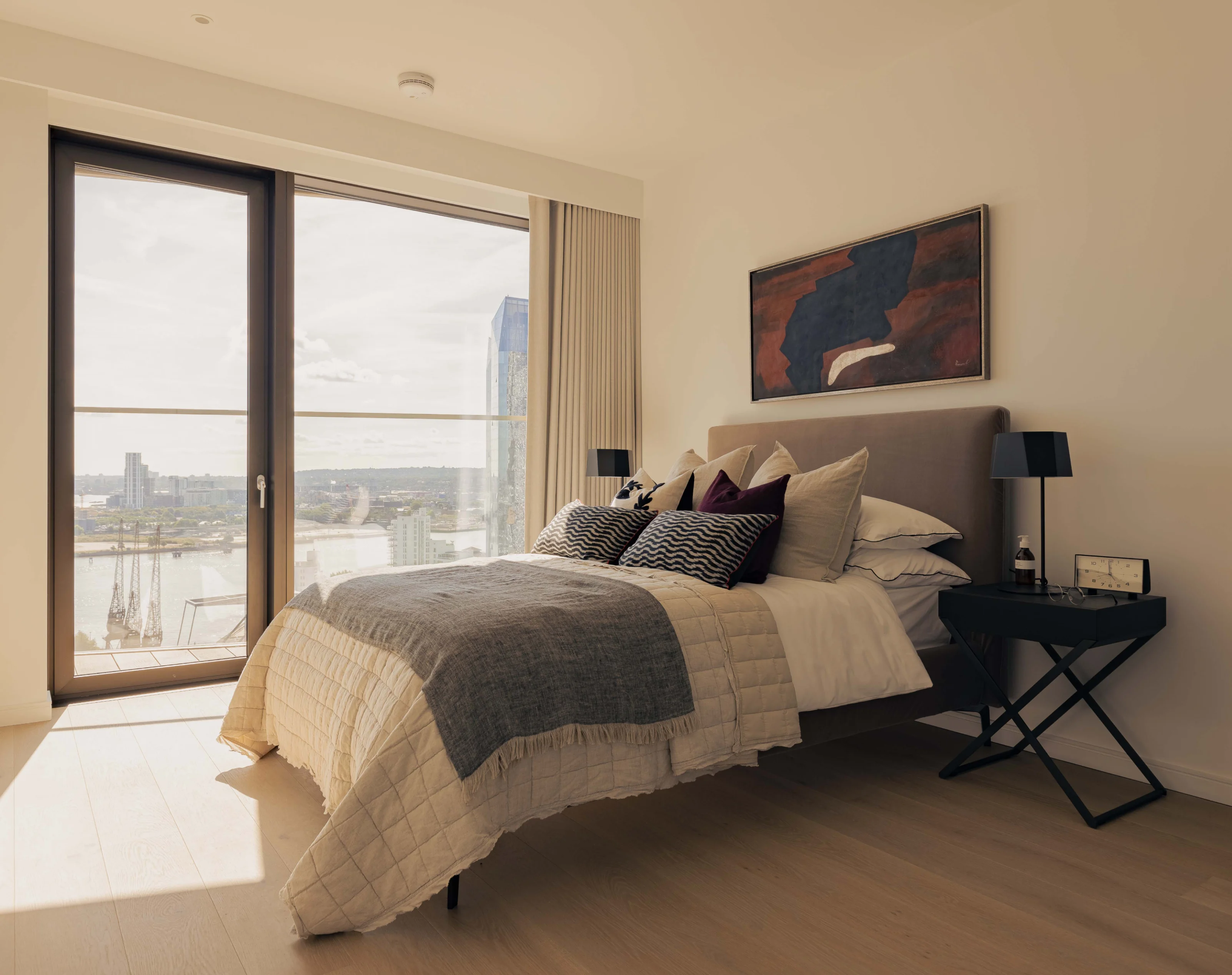 Comfortable bed with bedside table in one bedroom apartment in 10 george street