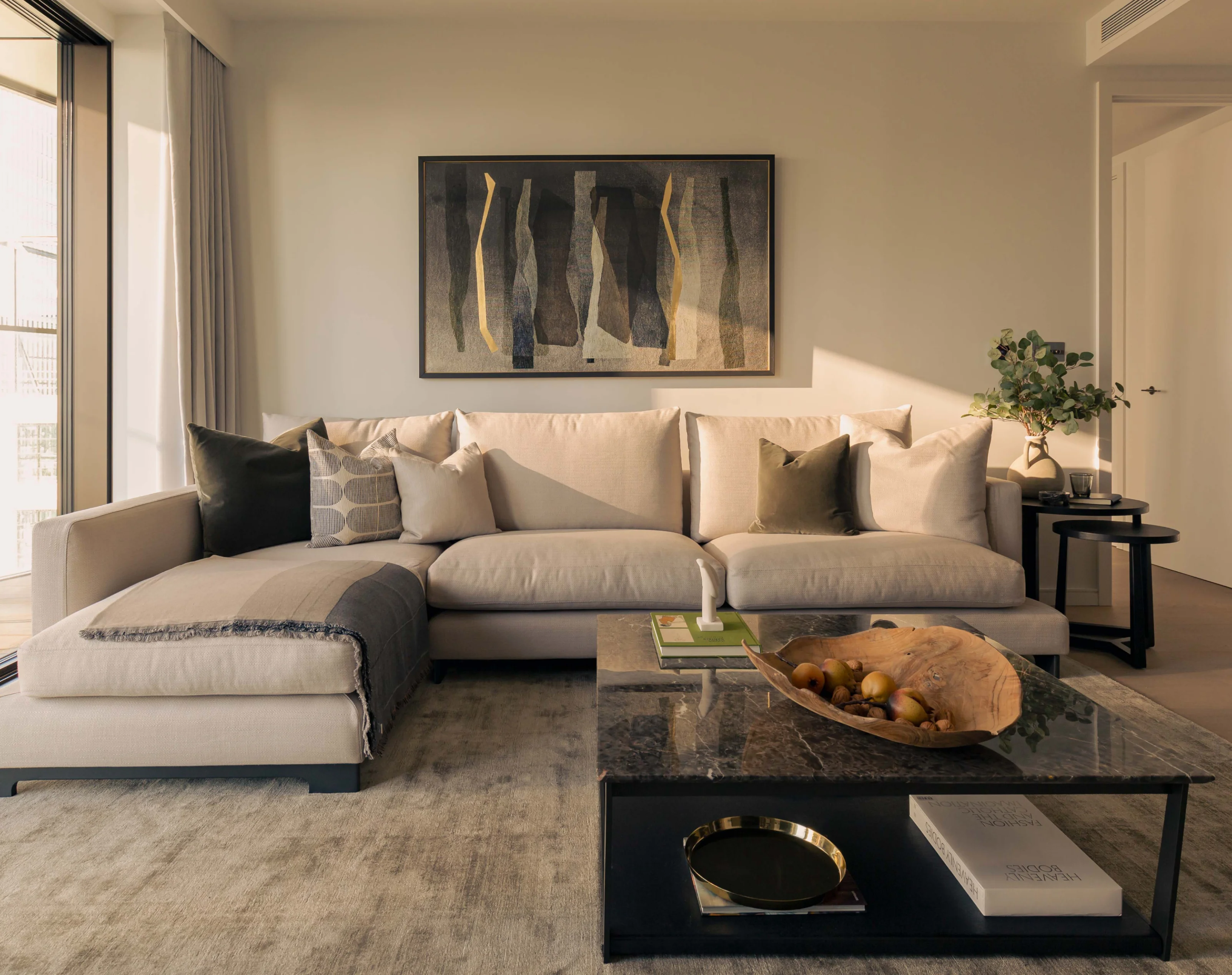 Comfortable sofa in living room with coffee table in one bedroom apartment in 10 george street