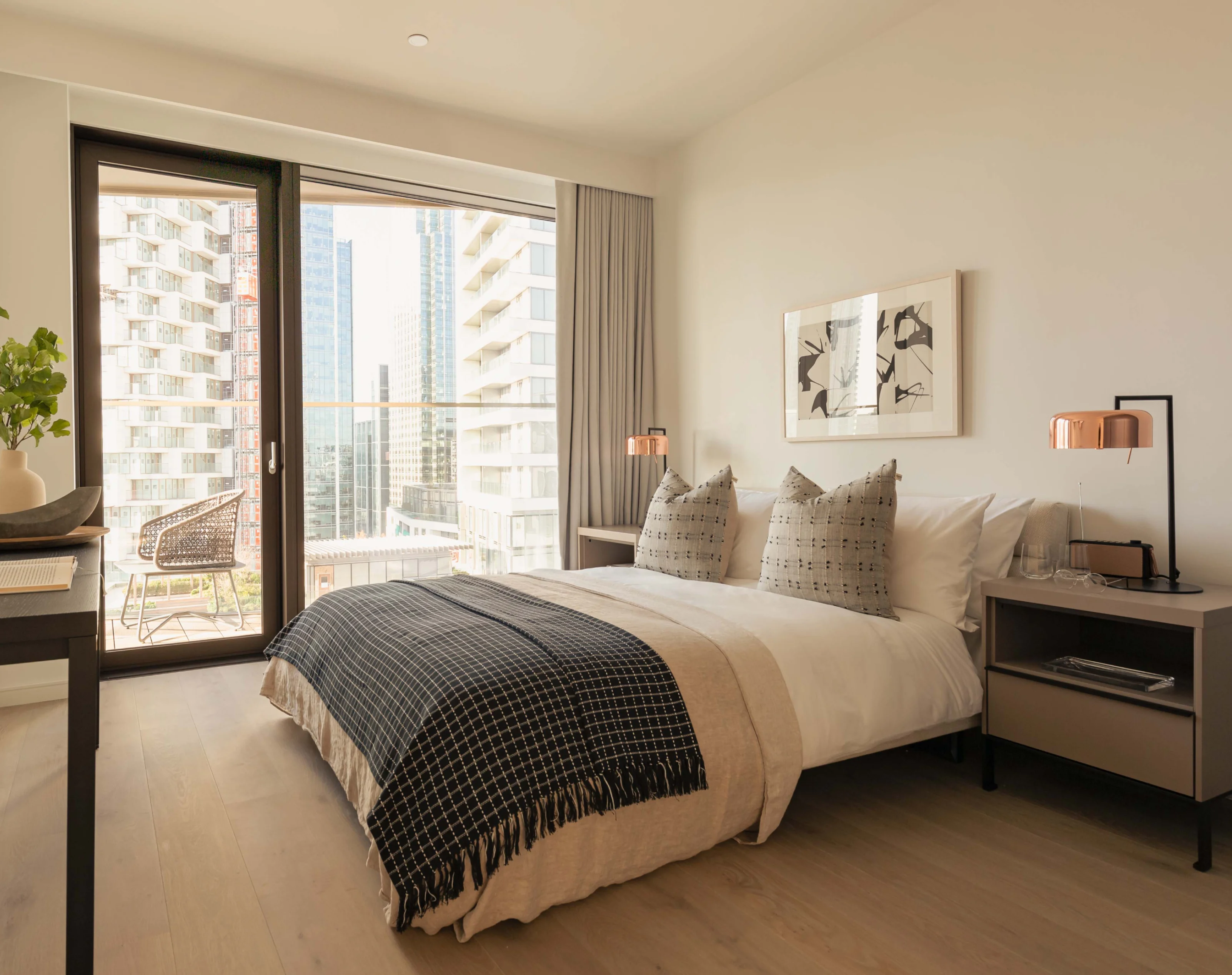 comfortable bed with bedside table and balcony in two bedroom apartment in 10 george street