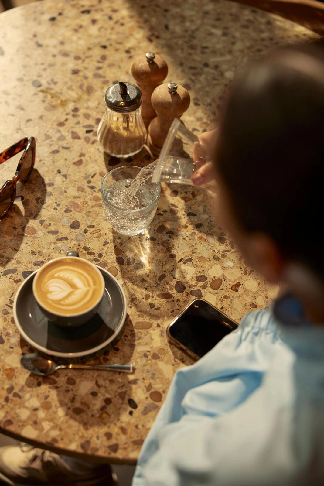 Lady enjoying coffee inside best coffee shop in canary wharf