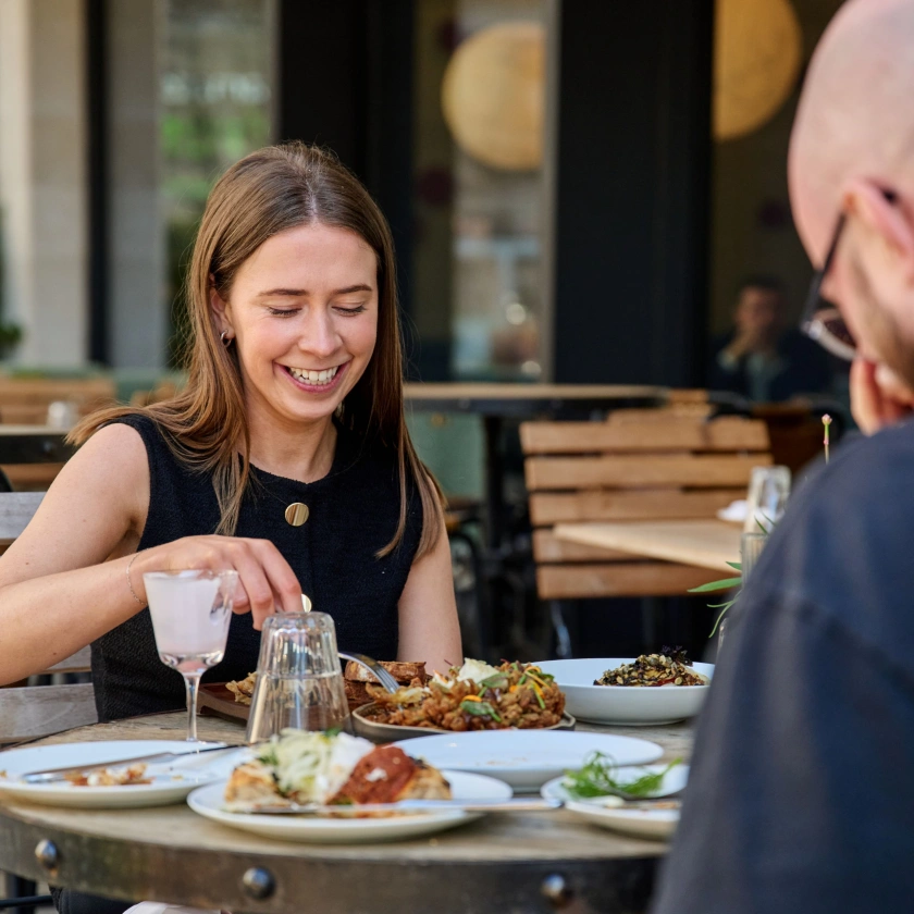 lady eating outside in restaurant