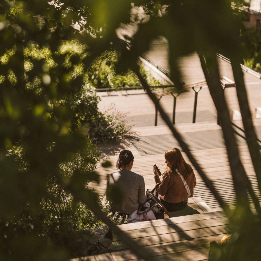 two girls sitting on Eden Dock Canary Wharf